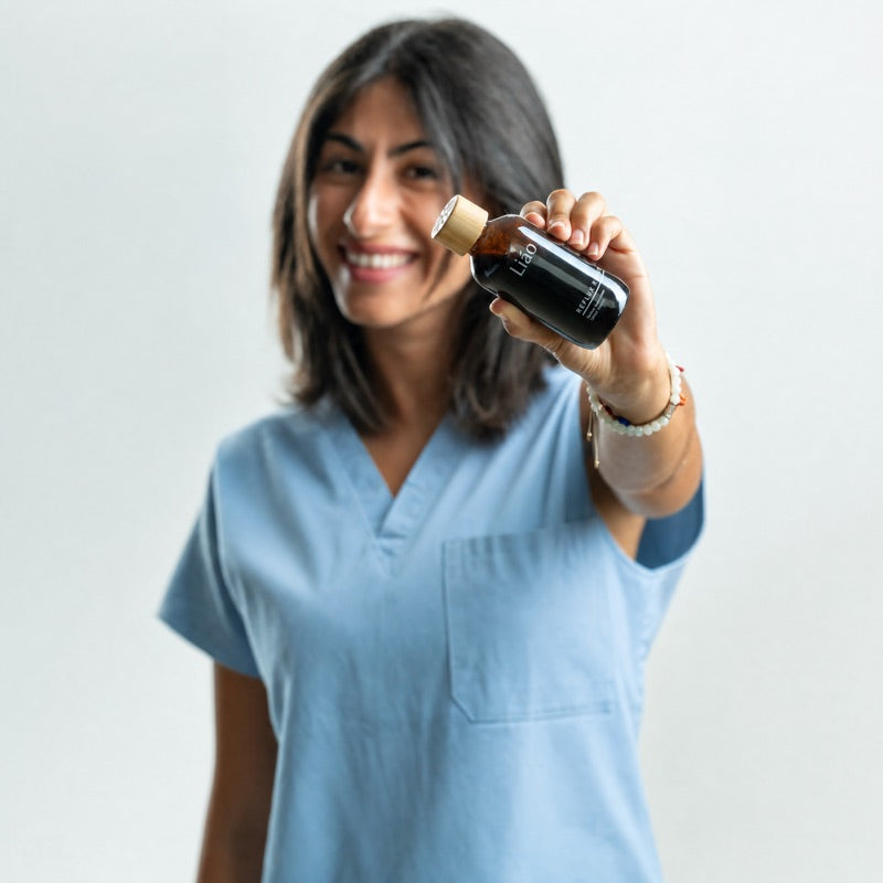 Dr. Lyda Kermani holding a bottle of Liao