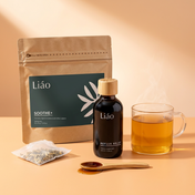 Root & Soothe Ritual: Liáo Reflux herbal syrup and Soothe+ Herbal Tea on peach